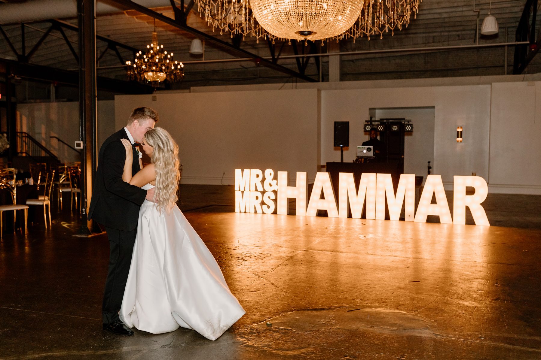 Bride and groom dancing with iSecret Records DJ booth visible in the background