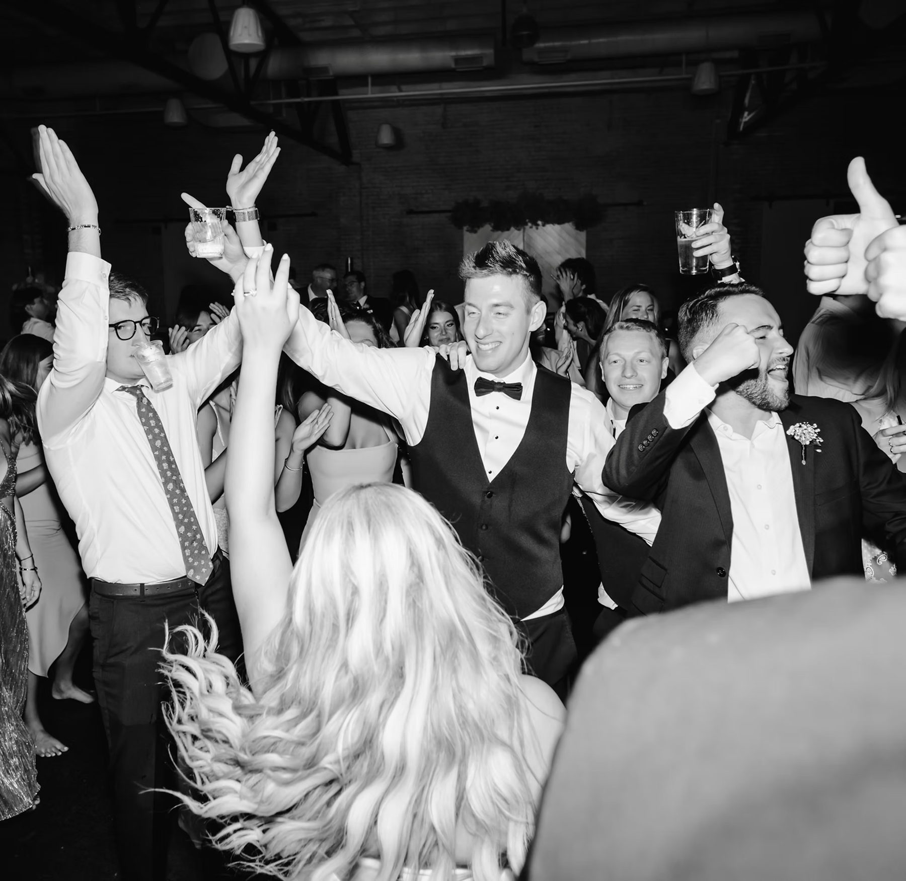iSecret Records wedding guests dancing with arms raised in Los Angeles